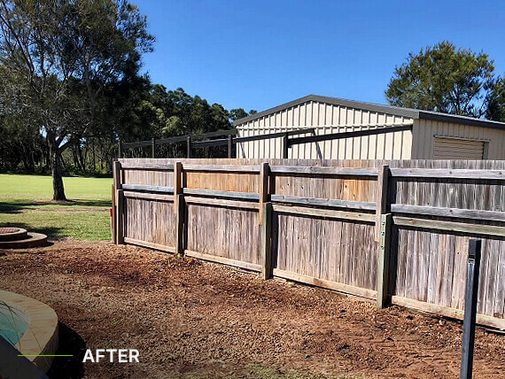 Dirt and fence where there was formerly a tree